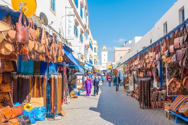 Colorful Moroccan textiles and leather slippers in a souk
